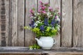 Bouquet of colorful wildflowers on an old wooden background. Still life with wild flowers Royalty Free Stock Photo