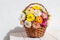 Bouquet of colourful  strawflowers in a wickery basket - autum decoration of golden everlasting on the table Royalty Free Stock Photo