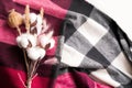 bouquet of cotton, fluffy ears of lagurus, poppy. the bouquet lies on a marsala-colored checkered fabric. cozy background Royalty Free Stock Photo