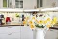 Bouquet of daffodils in interior of the kitchen Royalty Free Stock Photo