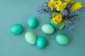 Bouquet of daffodils, tulips and Muscari.Easter. Easter eggs are blue and turquoise. Royalty Free Stock Photo