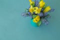 Bouquet of daffodils, tulips and Muscari.Easter. Easter eggs are blue and turquoise. Royalty Free Stock Photo