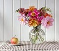 Bouquet of dahlias and Apple, light still life