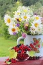 A bouquet of wildflowers and a glass bowl of red currant Royalty Free Stock Photo