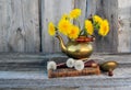 Bouquet of dandelions in a copper jug. Royalty Free Stock Photo