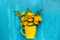 Bouquet dandelions taraxacum flowers in yellow mug on wood blue background Template for postcard, lettering, text or