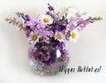 Bouquet of delphinium, chamomile and daylily. Flowers in a bouquet of country style in a glass vase.
