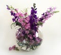 Bouquet of delphinium, chamomile and daylily. Flowers in a bouquet of country style in a glass vase. Royalty Free Stock Photo