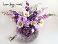 Bouquet of delphinium, chamomile and daylily. Flowers in a bouquet of country style in a glass vase. Royalty Free Stock Photo