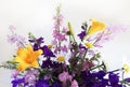 Bouquet of delphinium, chamomile and daylily. Flowers in a bouquet of country style in a glass vase.