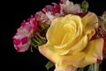 A bouquet of different colored flowers inside a glass vase isolated on black Royalty Free Stock Photo