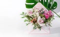 A bouquet of various flowers in a gift box. Place for text. Delicate flowers as a gift for a woman or girl. Festive postcard