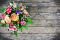 Bouquet of different flowers on an old wood table Royalty Free Stock Photo