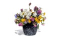 A bouquet of different wildflowers stands in a vase on a white background. Royalty Free Stock Photo