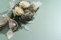 Bouquet of dried flowers placed on green background