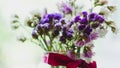 Bouquet of dried violet, pink and white wildflowers. Bright flowers lit by sunlight. Soft selective focus, macro flowers. Photo