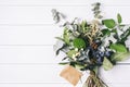 Bouquet of dried wild flowers on white table background with natural wood vintage planks wooden texture top view horizontal Royalty Free Stock Photo