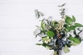 Bouquet of dried wild flowers on white table background with natural wood vintage planks wooden texture top view horizontal Royalty Free Stock Photo