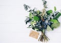 Bouquet of dried wild flowers on white table background  with natural wood vintage planks wooden texture top view horizontal Royalty Free Stock Photo