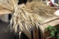 Bouquet of dry spikelets, wheat ears close-up on the table, selective focus, decorative ripened cereal spikes. Autumn