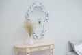 A bouquet of dry wildflowers stands in a white vase on a boudoir table by a vintage mirror Royalty Free Stock Photo