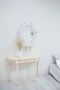 A bouquet of dry wildflowers stands in a white vase on a boudoir table by a vintage mirror Royalty Free Stock Photo