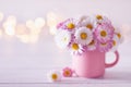 Bouquet of English daisy flowers in cup. Spring still life with little chamomile. Mother or Woman day card