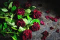 Bouquet of faded red roses with dead petals on the floor