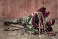 Bouquet of faded roses with catholic rosary