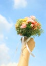Bouquet of flower in hand and sky Royalty Free Stock Photo