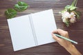 Bouquet of flower with hand writing on empty diary notebook rustic wooden table with copy space, mockup template Royalty Free Stock Photo