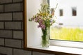 Bouquet of flowers in a vase on the window Royalty Free Stock Photo