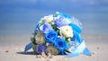 Bouquet flowers on the beach white sand tropical paradise island on sea water ocean background and cloudy sky Royalty Free Stock Photo