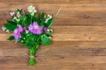 Bouquet of flowers of clover, cornflowers and Jasmine on a wooden retro brown background