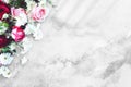 Bouquet of flowers on a concrete table. Red and pink roses, white daisies. Old white and gray background. Floral mockup for Royalty Free Stock Photo