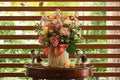 Bouquet of flowers and a figurine of a girl and a boy on a small table on the veranda Royalty Free Stock Photo