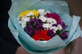 A bouquet of flowers in the girl`s hand.