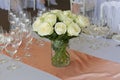 Bouquet of flowers in a glass vase on the festive table in the restaurant Royalty Free Stock Photo