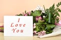 Flowers and greeting card with I Love You message Royalty Free Stock Photo