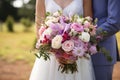 Bouquet of flowers in the hands of the bride with the groom