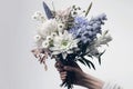 bouquet of flowers in hands with white Chrysanthemums, blue Iris, snowdrops, lilies Royalty Free Stock Photo