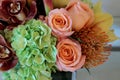 Bouquet of flowers including roses, orchids, pincushion proteas