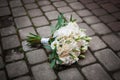 Bouquet of flowers lies on the pavement Royalty Free Stock Photo
