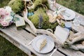 Bouquet of flowers lies on a served wedding table with candles and invitations Royalty Free Stock Photo