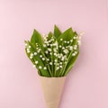 Bouquet of flowers lily of the valley on pink pastel background, beautiful breakfast, vintage romantic card, top view, flat lay.