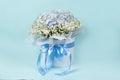 Bouquet of flowers made of hydrangeas and gypsophila in a white box with a bow Royalty Free Stock Photo