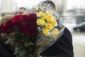 Bouquet of flowers. Man holds flowers in his hand. Details of holiday Royalty Free Stock Photo