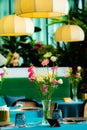 A bouquet of flowers in a vase on a table in the dining room.