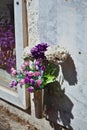 A bouquet of flowers next to a niche on a sunny day