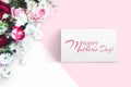 Bouquet of flowers, red and pink roses, white daisies on a white and pink background. Inscription Happy Mother`s Day. Advertising Royalty Free Stock Photo